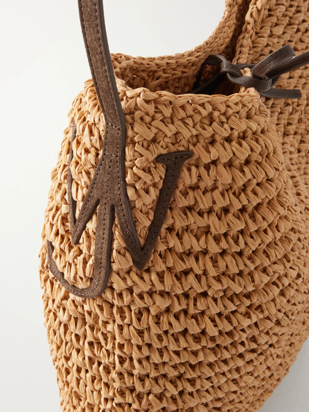 Close-up detail of the JW Anderson Bulb Large Suede-trimmed Raffia Tote