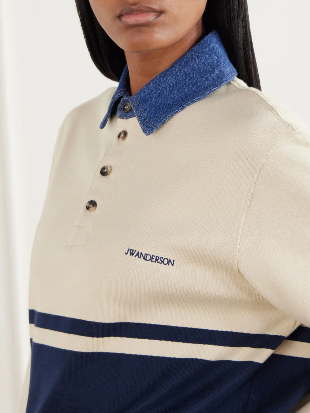Close-up detail of the JW Anderson Contrast Collar Embroidered Striped Cotton-jersey Polo Shirt