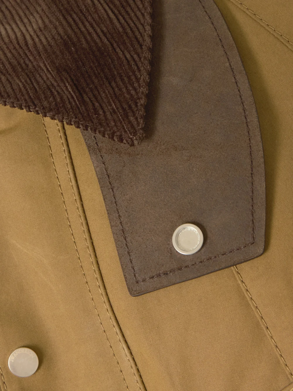 Close-up detail of the JW Anderson Cropped Corduroy-trimmed Waxed-cotton Jacket