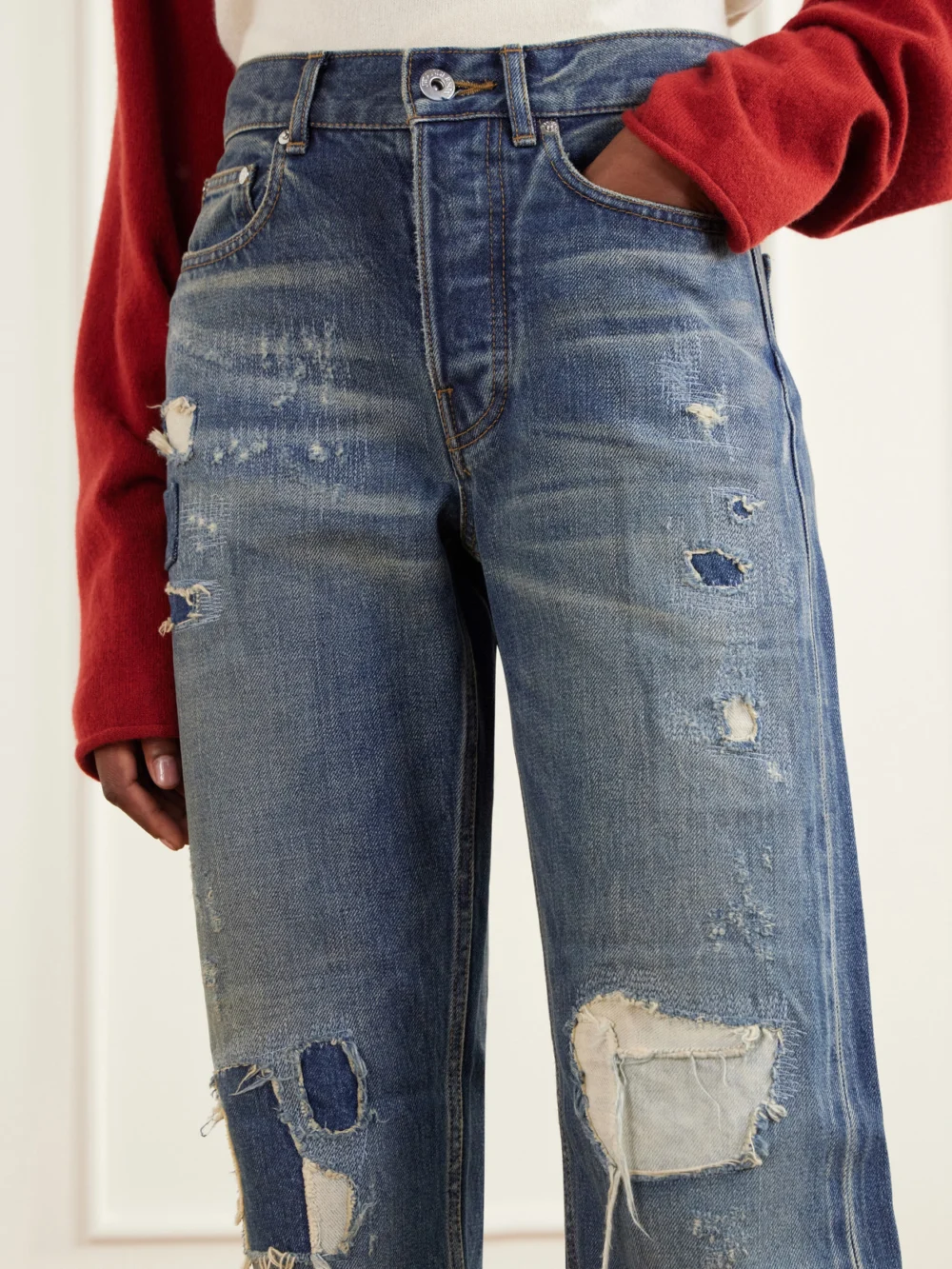 Close-up detail of the JW Anderson Distressed Mid-rise Straight-leg Jeans