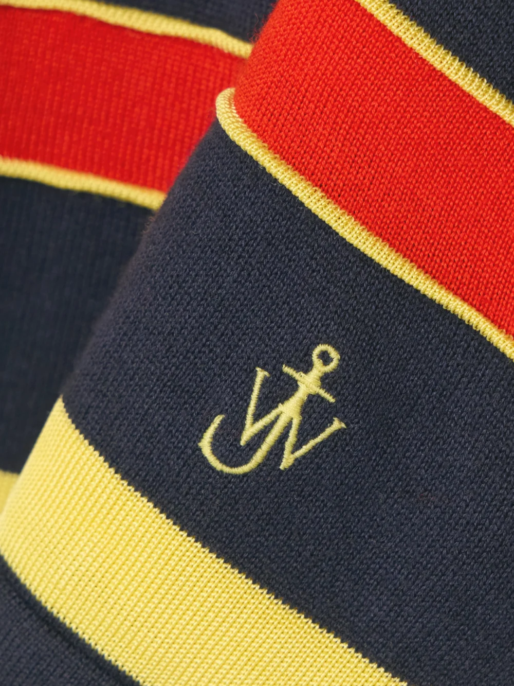 Close-up detail of the JW Anderson Embroidered Striped Cotton and Wool-blend Polo Shirt