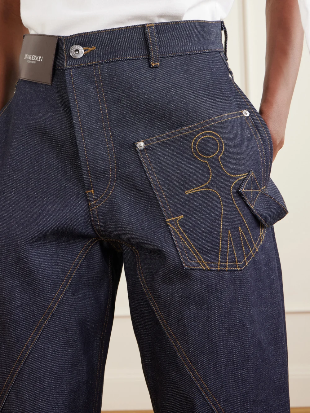 Close-up detail of the JW Anderson High-rise Embroidered Wide-leg Jeans
