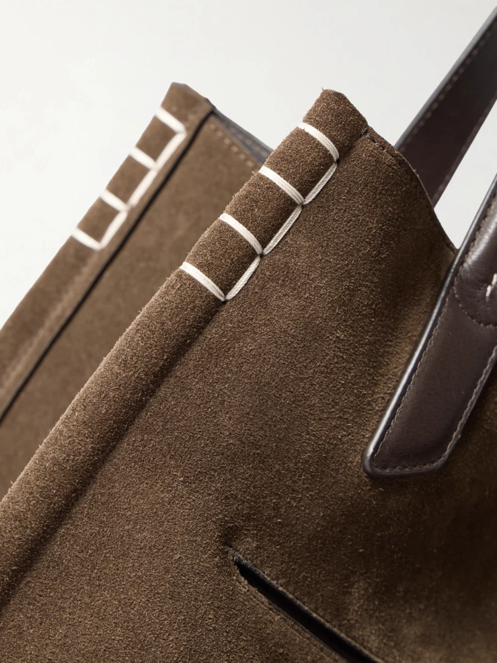 Close-up detail of the JW Anderson Loafer Cabas Tasseled Leather-trimmed Suede Shoulder Bag
