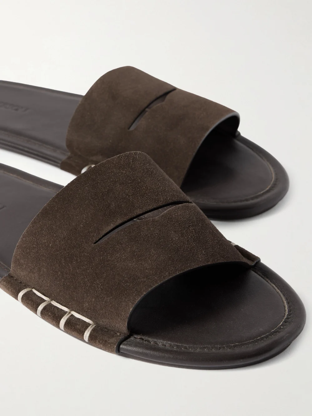 Close-up detail of the JW Anderson Loafer Whipstitched Suede Slides