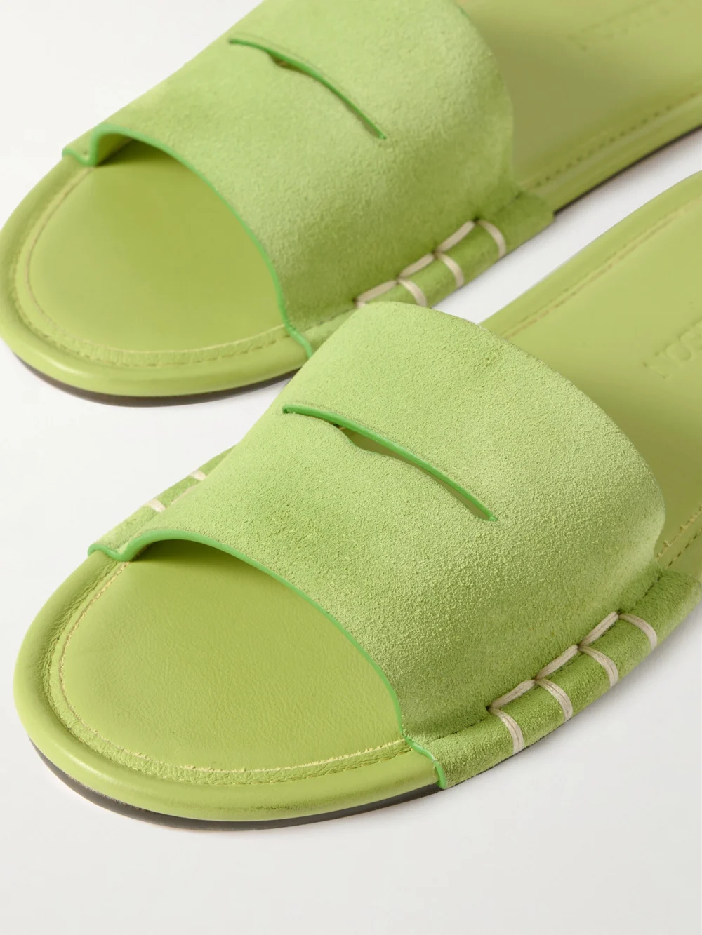 Close-up detail of the JW Anderson Loafer Whipstitched Suede Slides