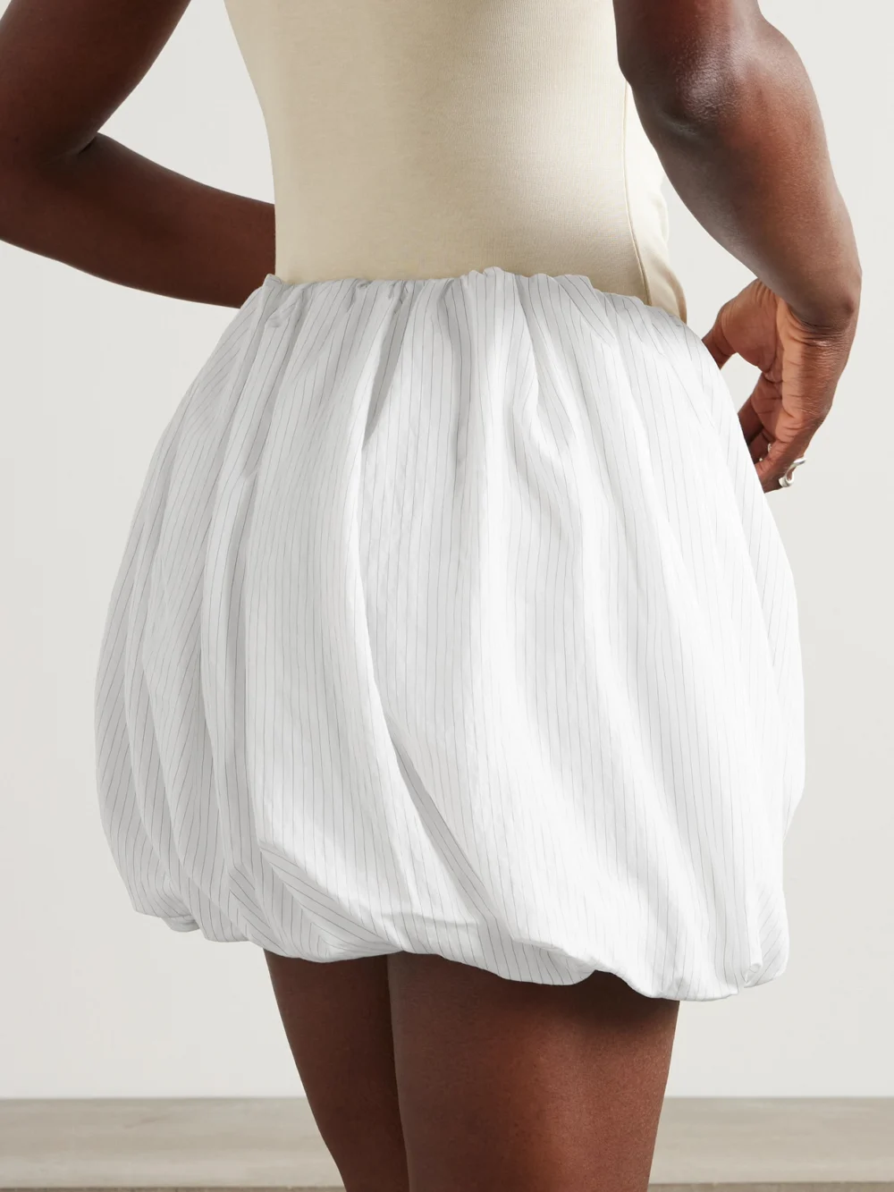 Back view of the JW Anderson Pleated Pinstriped Poplin Mini Skirt