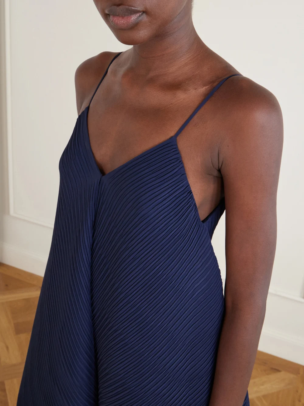 Close-up detail of the JW Anderson Tiered Asymmetric Pleated Crepe De Chine Mini Dress