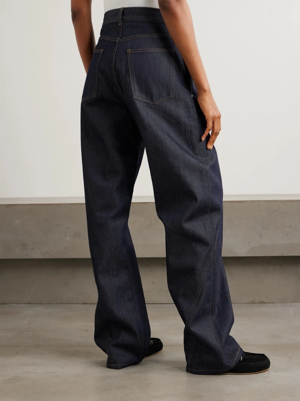 Back view of the JW Anderson Twisted Asymmetric Embroidered High-rise Jeans