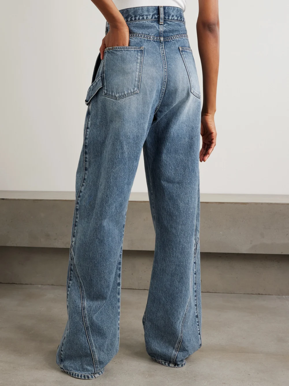 Back view of the JW Anderson Twisted Asymmetric Embroidered High-rise Jeans