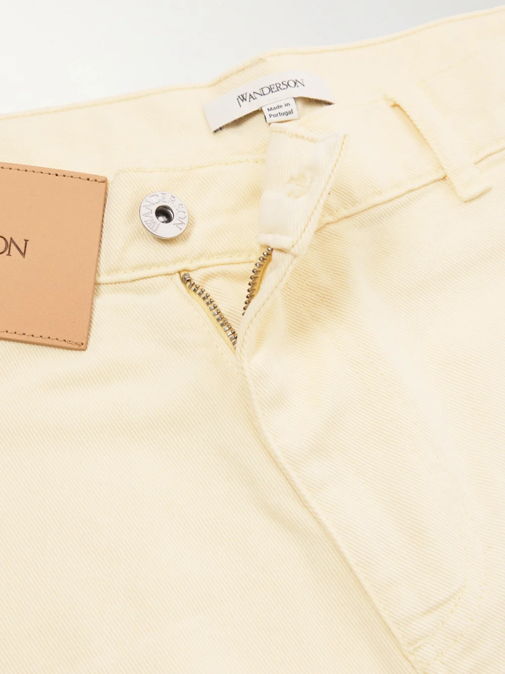Close-up detail of the JW Anderson Twisted Low-rise Wide-leg Jeans