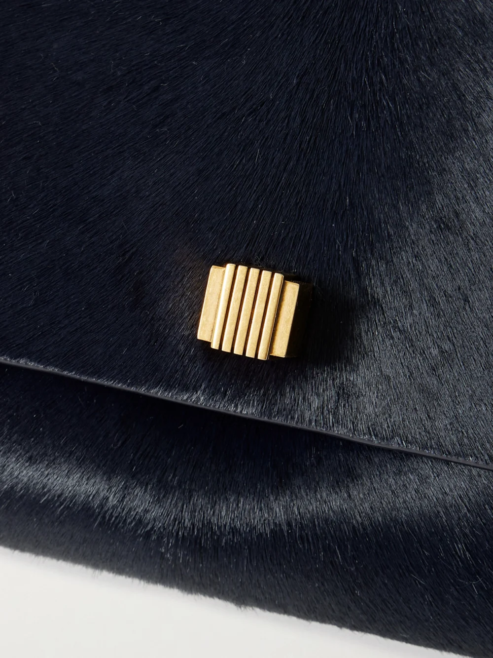 Close-up detail of the Khaite Audrey Calf Hair Clutch