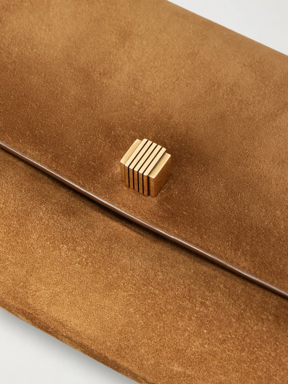 Close-up detail of the Khaite Audrey Suede Clutch