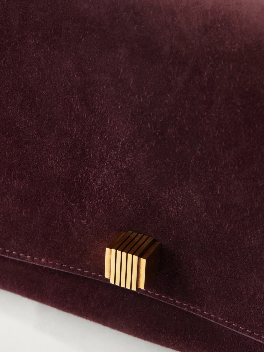 Close-up detail of the Khaite Audrey Suede Clutch