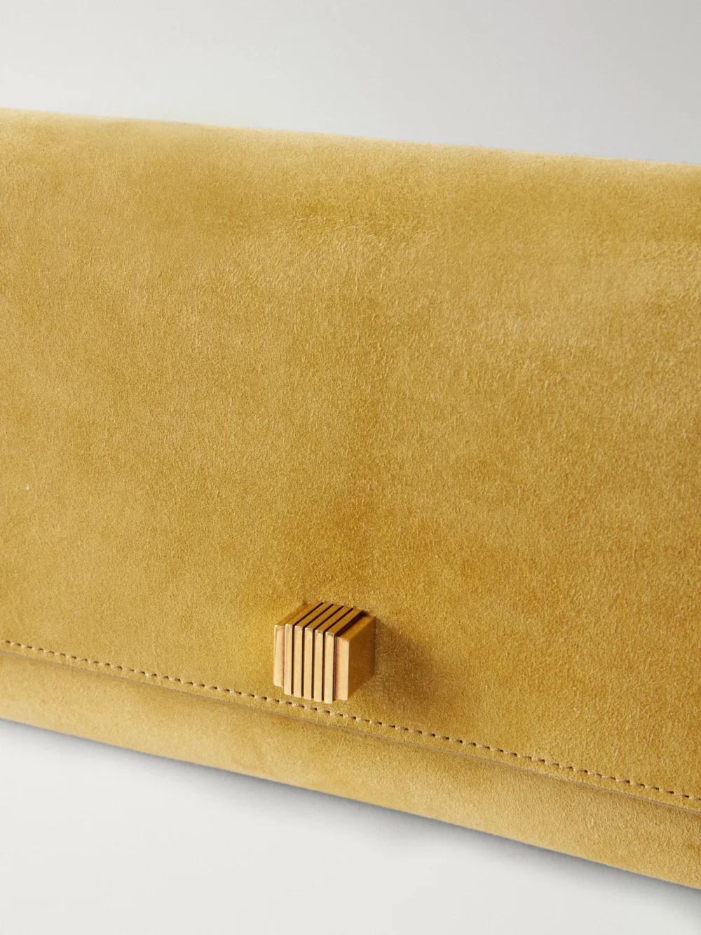 Close-up detail of the Khaite Audrey Suede Clutch