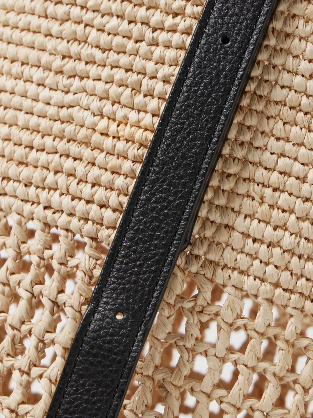 Close-up detail of the Khaite Billie Leather-trimmed Two-tone Raffia Bucket Bag