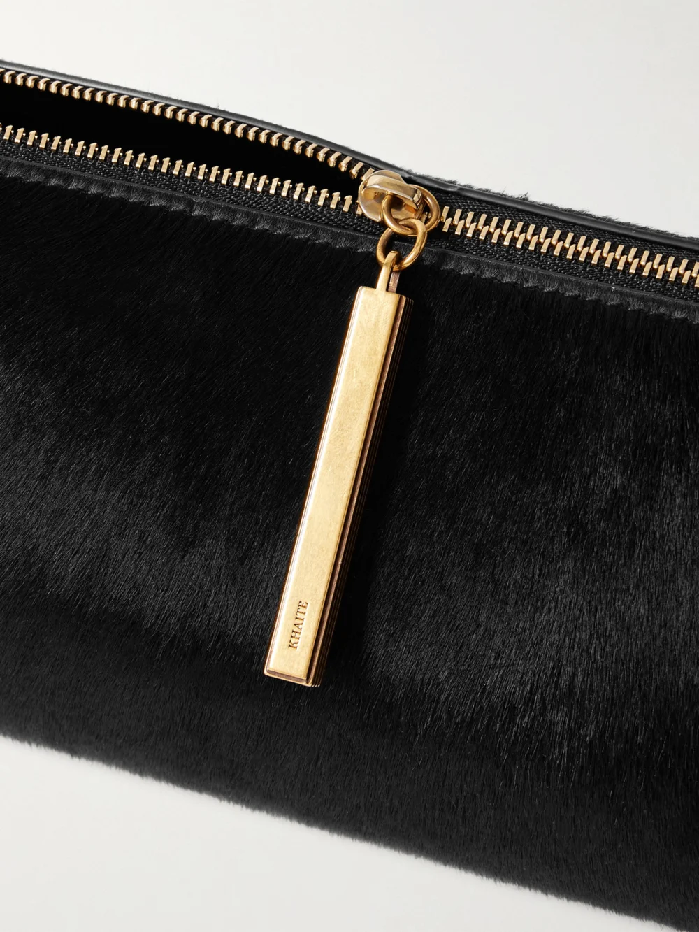 Close-up detail of the Khaite Kye Calf Hair Clutch