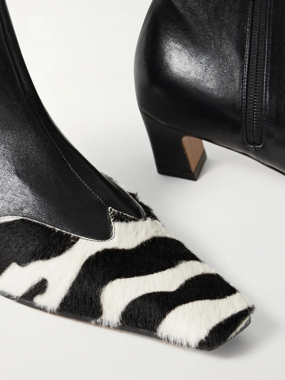 Close-up detail of the Khaite Nevada Leather and Zebra-print Calf Hair Ankle Boots