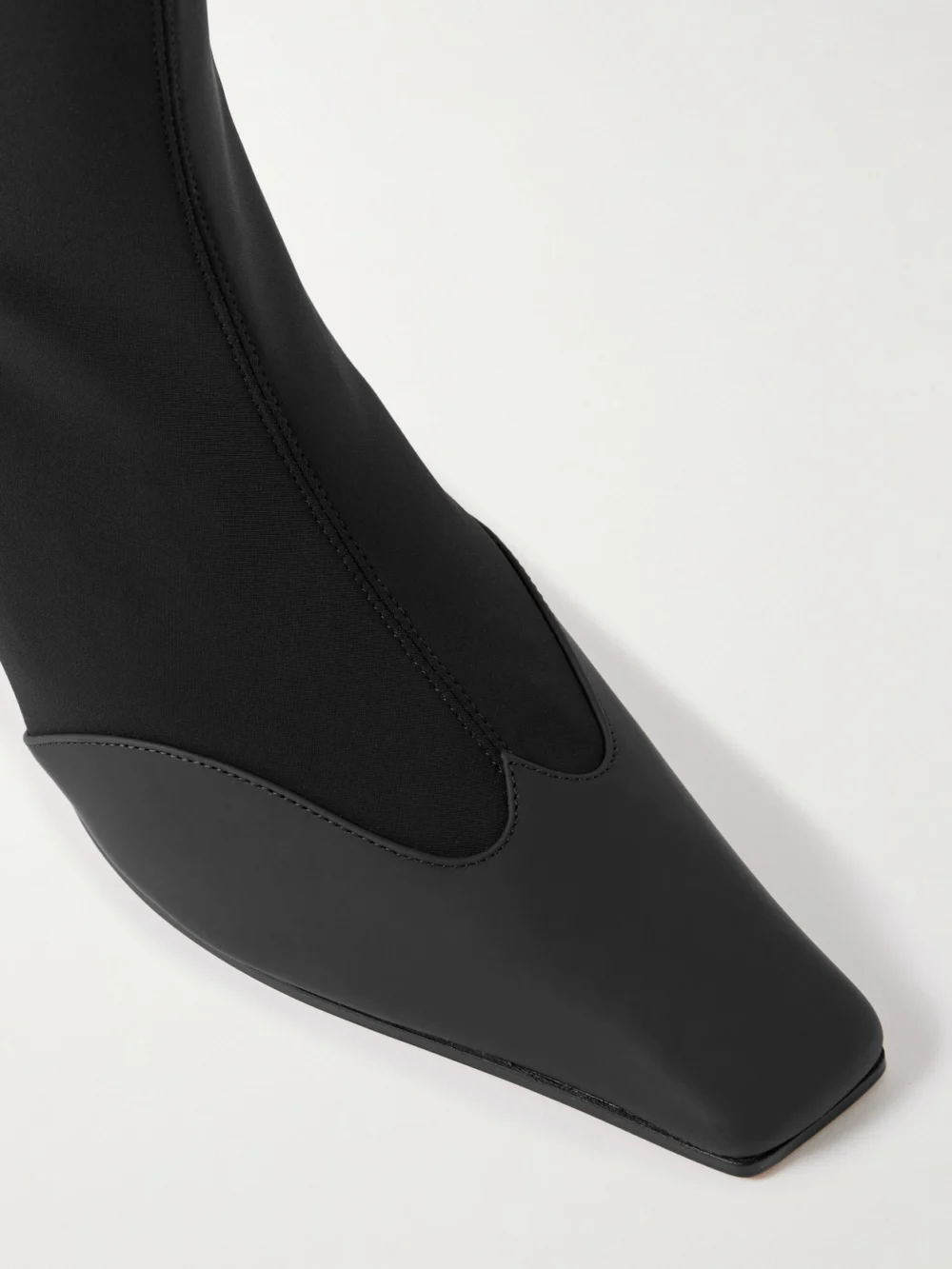 Close-up detail of the Khaite Nevada Leather-trimmed Stretch-knit Ankle Boots