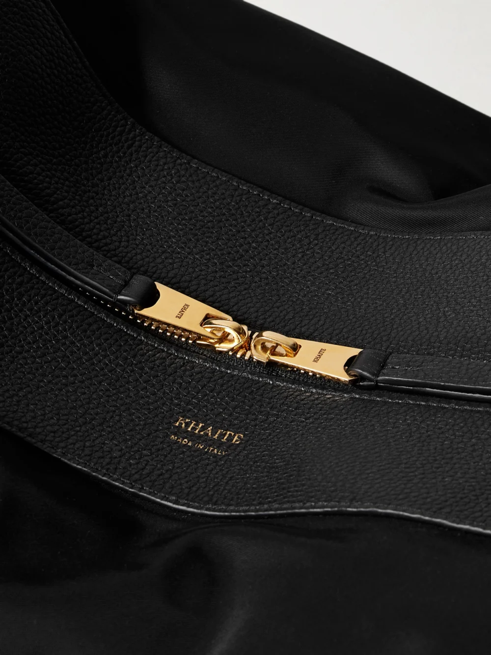 Close-up detail of the Khaite Olivia Sport Xl Textured Leather-trimmed Shell Shoulder Bag