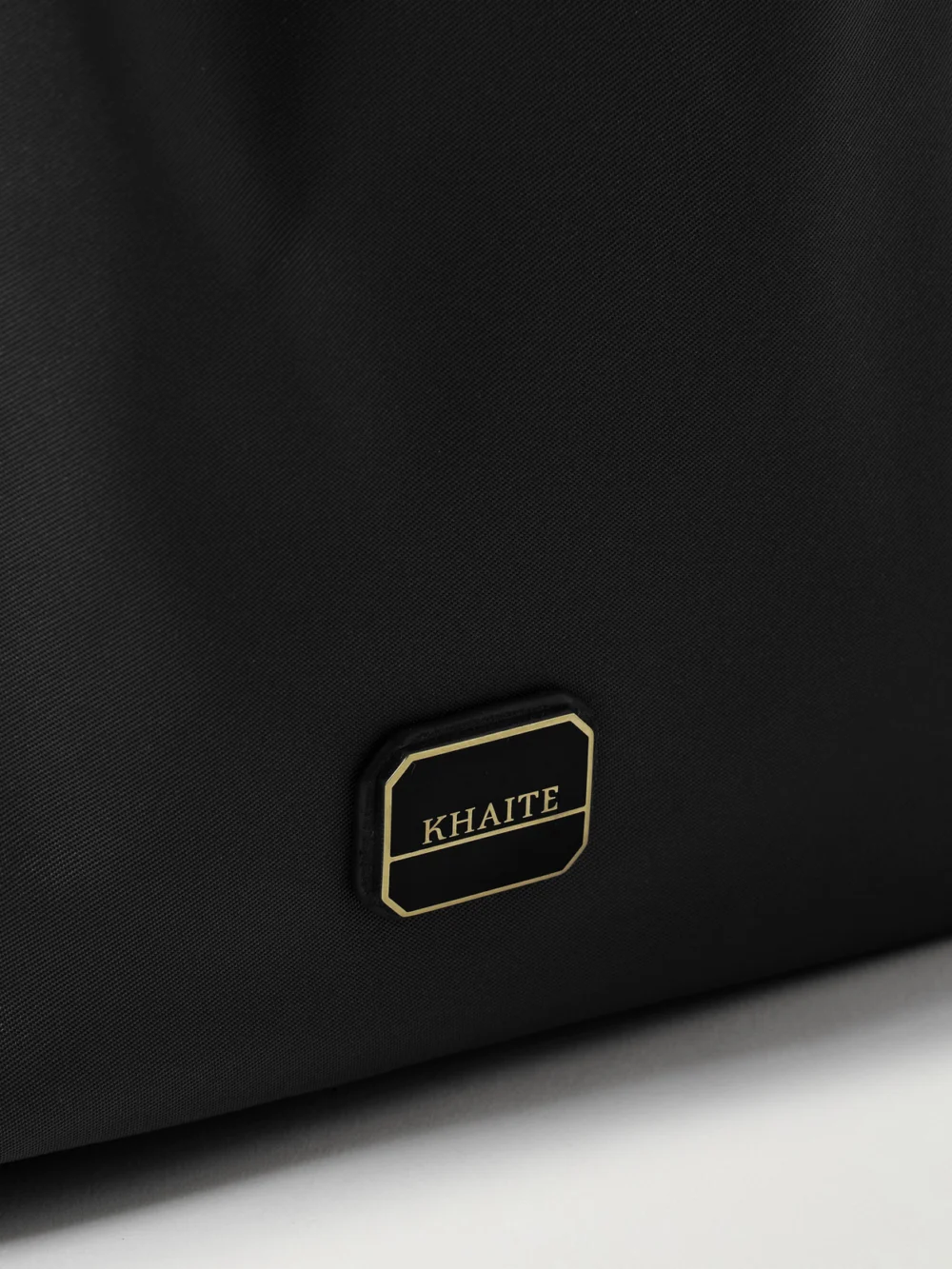 Close-up detail of the Khaite Rory Leather-trimmed Shell Bucket Bag