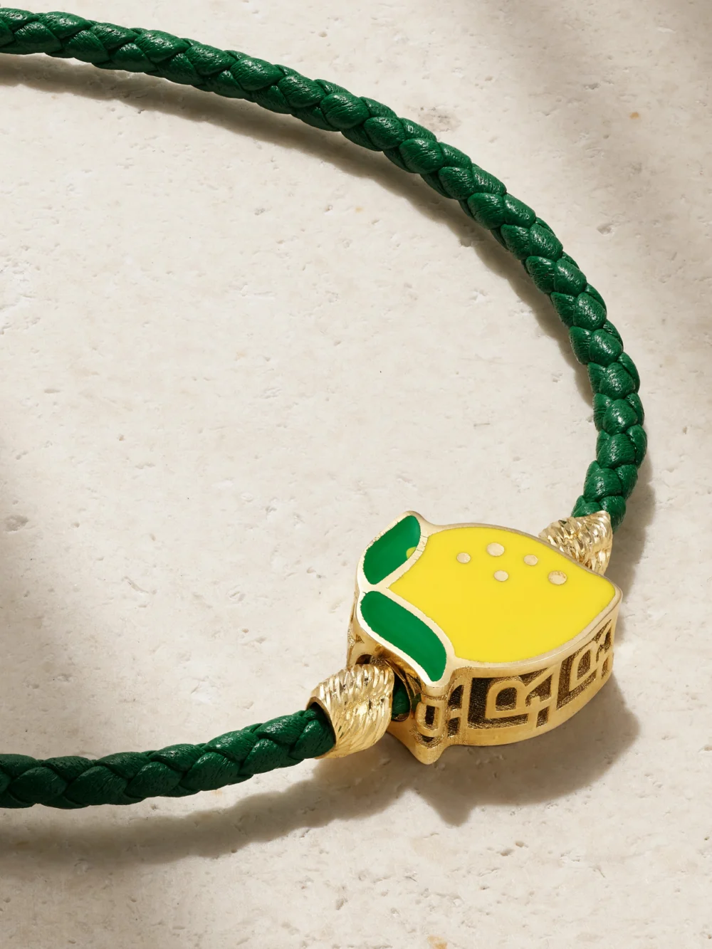 Close-up detail of the Lauren Rubinski Lemon 14-karat Gold, Enamel and Leather Bracelet