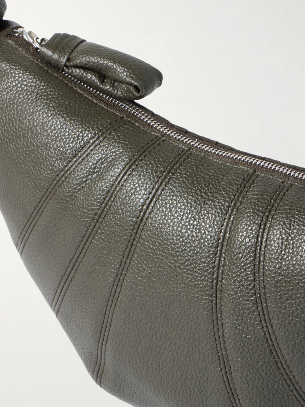 Close-up detail of the Lemaire Croissant Small Paneled Textured-leather Shoulder Bag