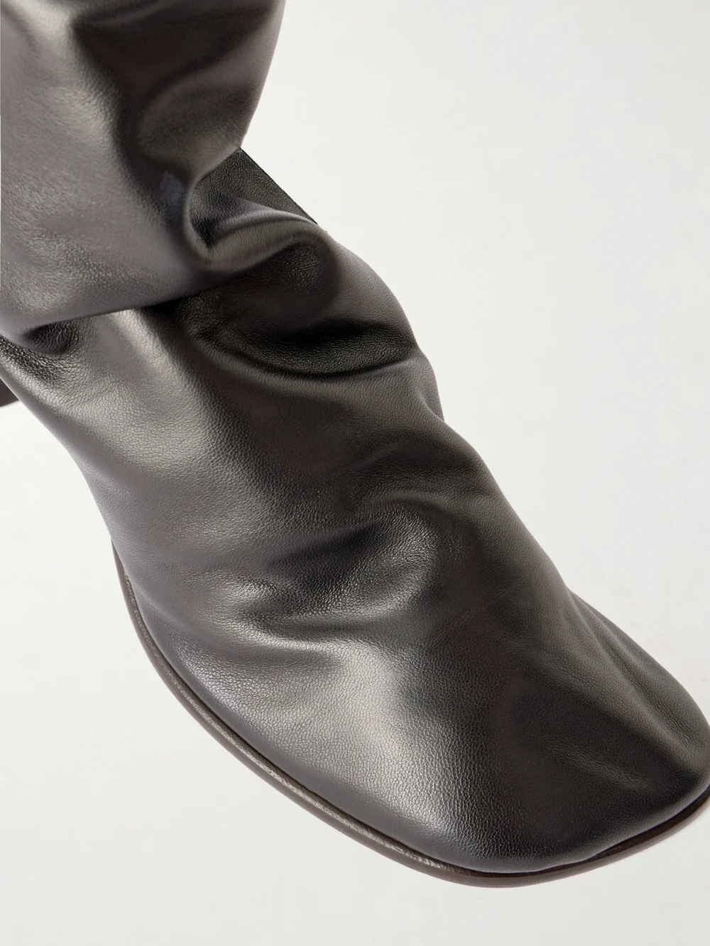 Close-up detail of the Lemaire Leather Knee Boots