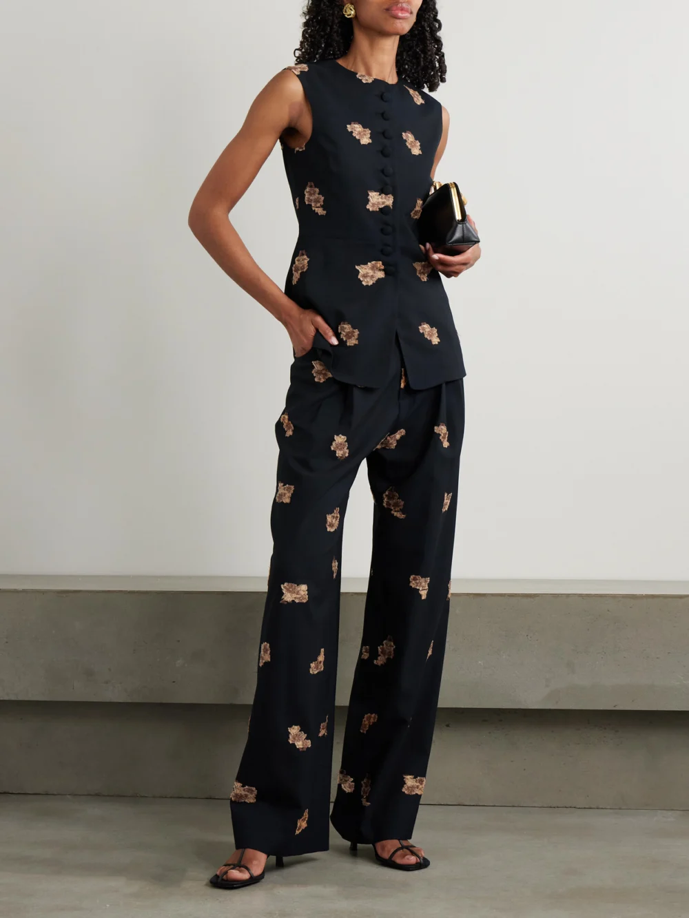 Liberowe Annie Pleated Floral-jacquard Metallic Wool-blend Wide-leg Pants, worn by a model