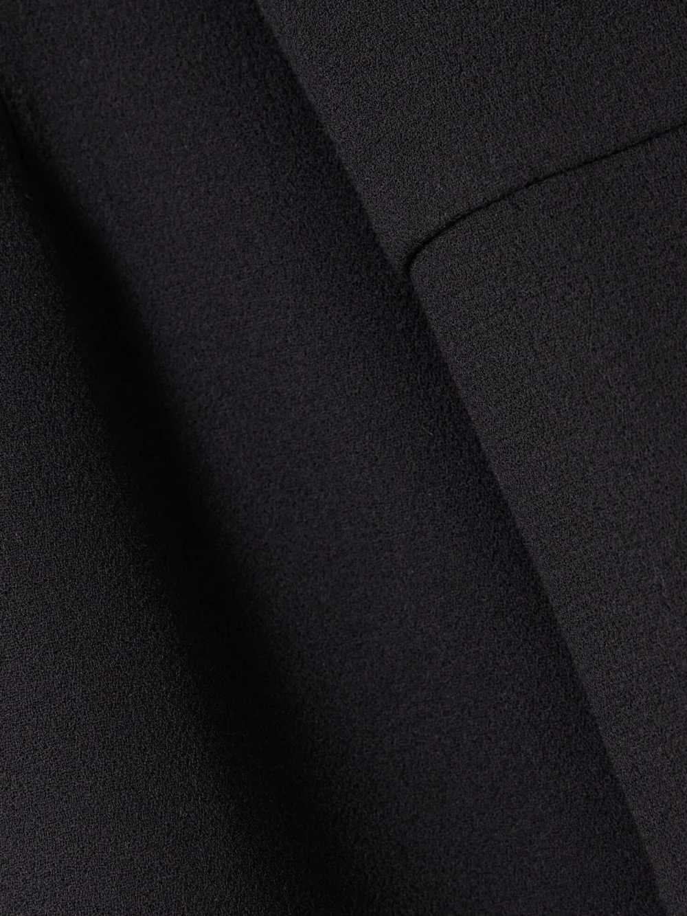 Close-up detail of the Liberowe + the Vanguard Amber Wool-crepe Mini Dress