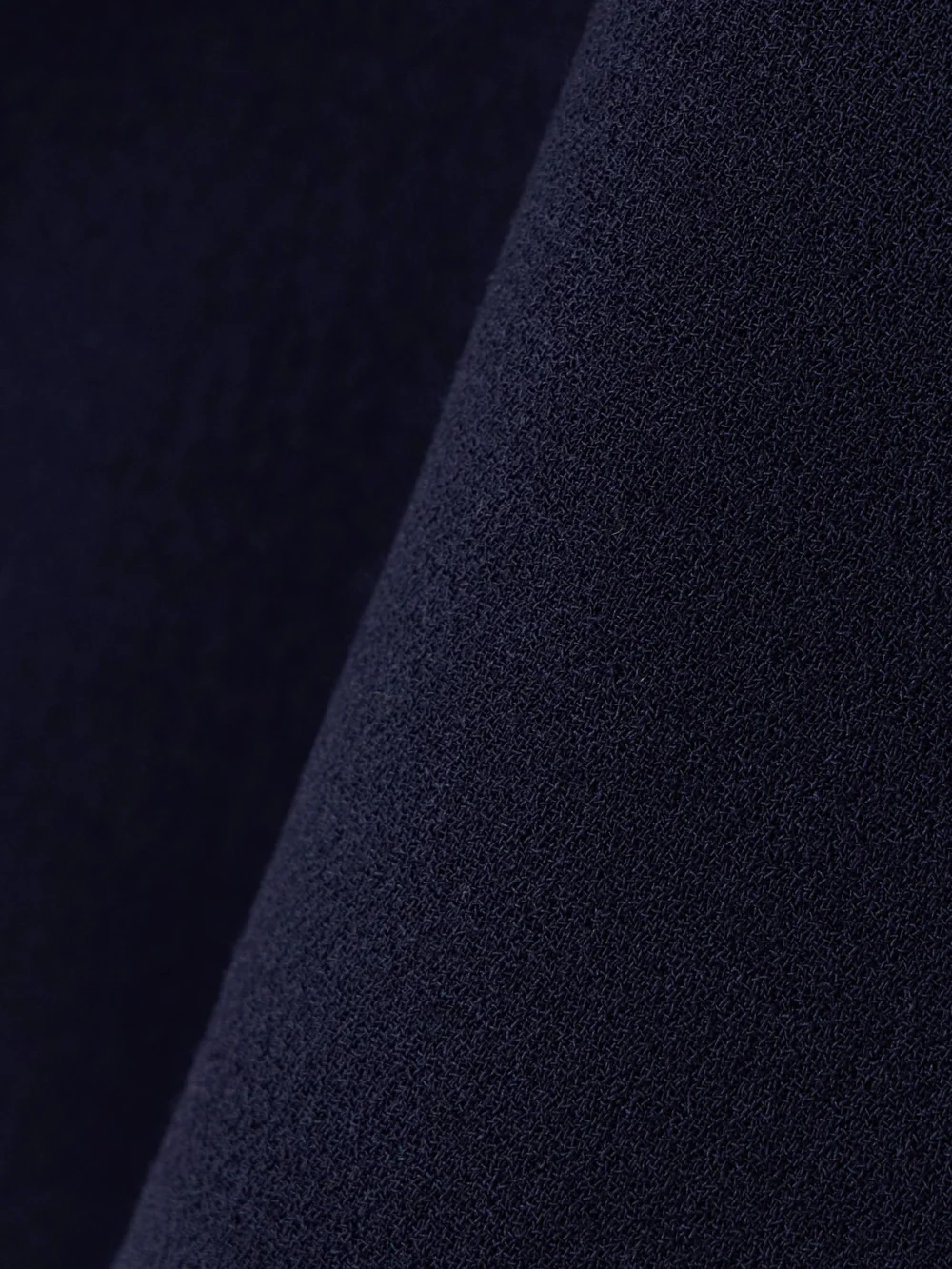 Close-up detail of the Liberowe + the Vanguard Vera Paneled Wool Mini Skirt