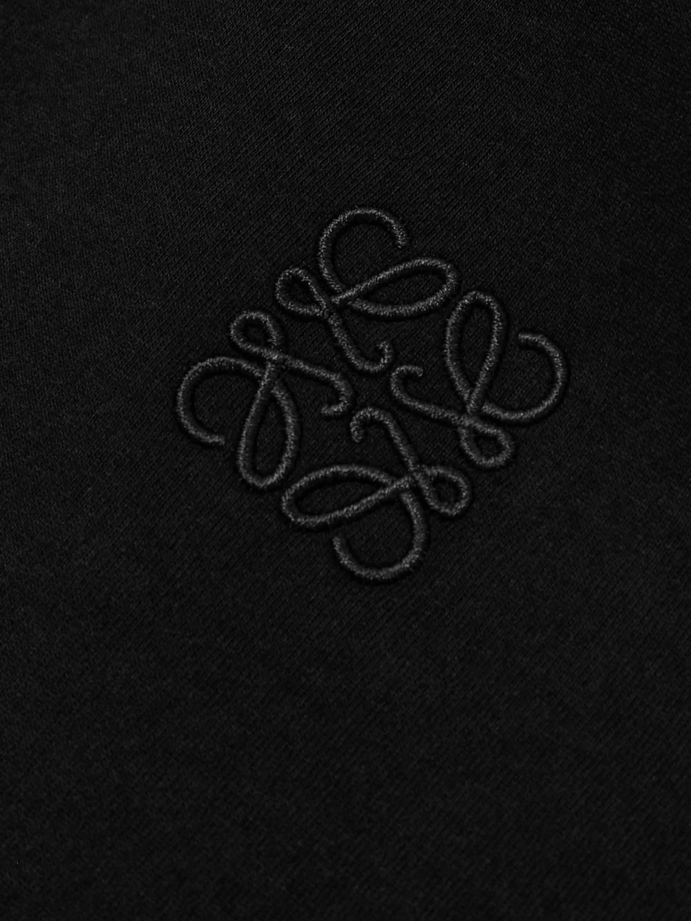 Close-up detail of the Loewe Anagram Asymmetric Cotton-blend Jersey T-shirt