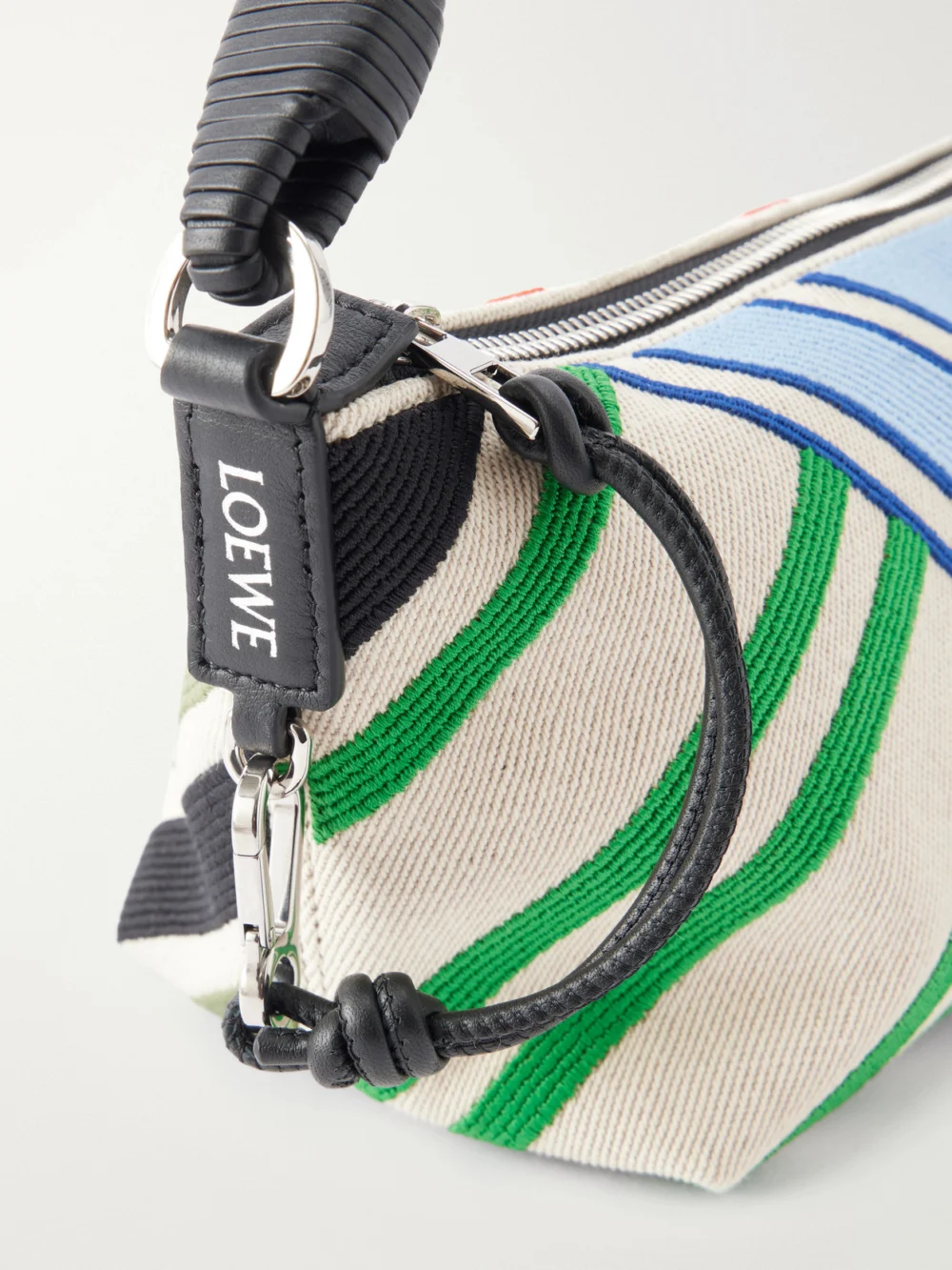 Close-up detail of the Loewe Cala Bayadere Leather-trimmed Paneled Striped Canvas Shoulder Bag