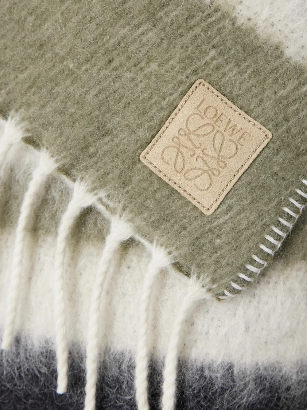 Close-up detail of the Loewe Hooded Fringed Scarf-detailed Striped Wool-blend Coat