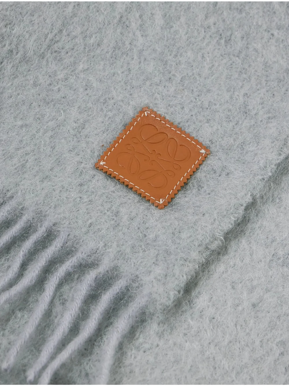 Close-up detail of the Loewe Leather-trimmed Fringed Mohair-blend Scarf