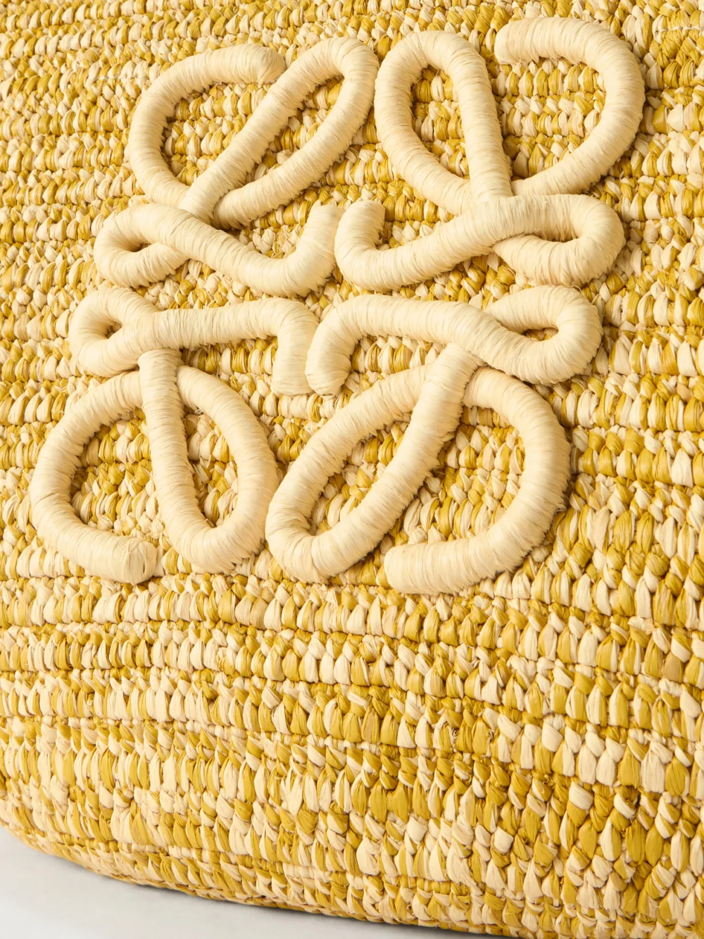 Close-up detail of the Loewe + Paula's Ibiza Eclipse Basket Medium Leather-trimmed Raffia Tote