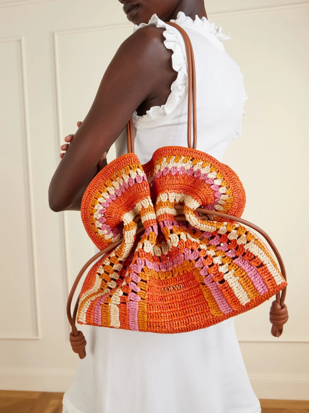 Loewe + Paula's Ibiza Flamenco Mini Leather-trimmed Crocheted Raffia Clutch, styled view