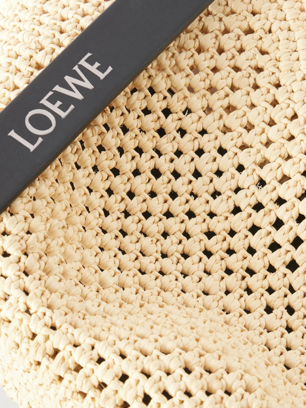 Close-up detail of the Loewe + Paula's Ibiza Punch Hole Mini Leather-trimmed Raffia Shoulder Bag