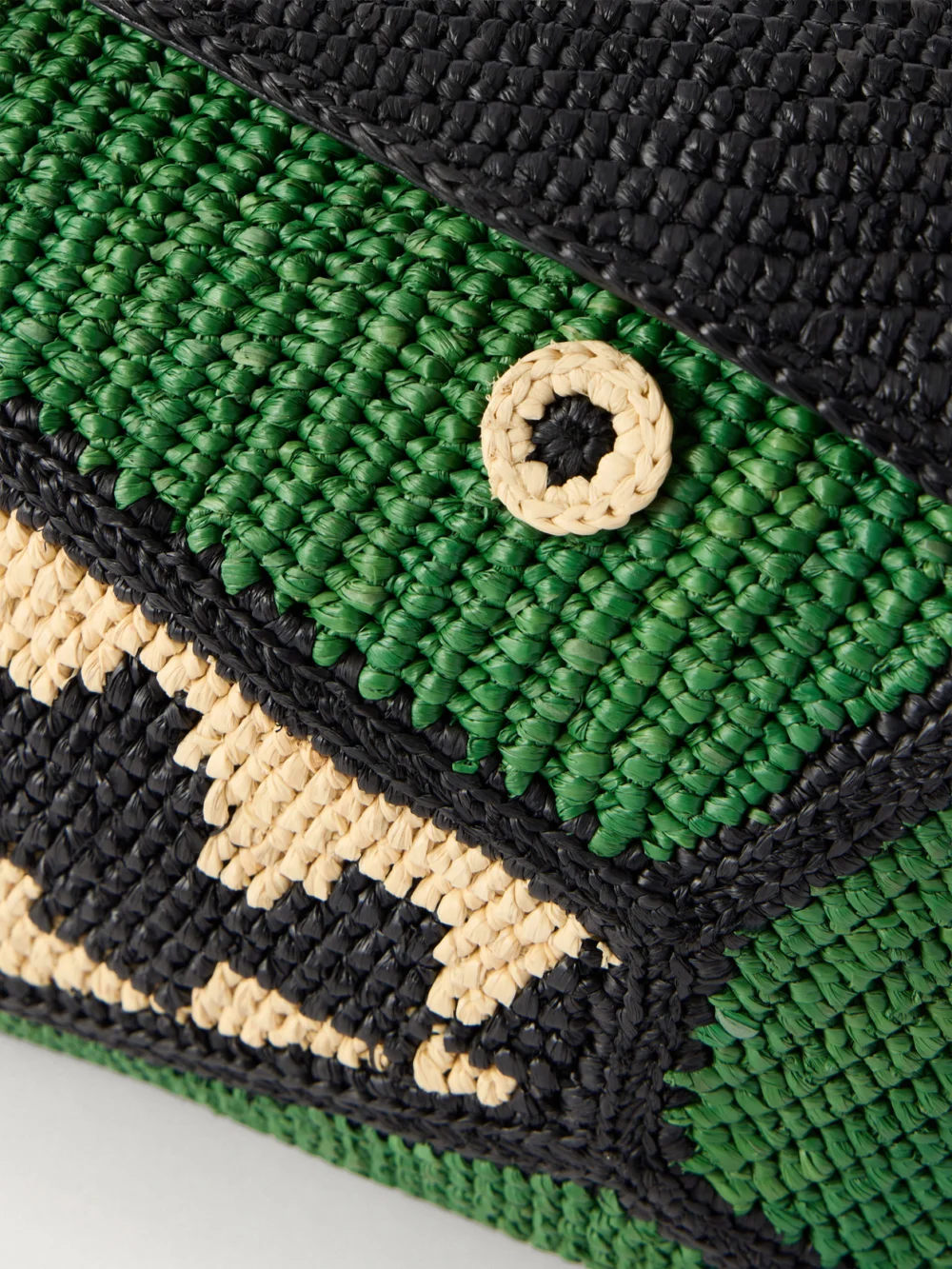 Close-up detail of the Loewe + Paula's Ibiza Puzzle Edge Crocodile Leather-trimmed Raffia Shoulder Bag