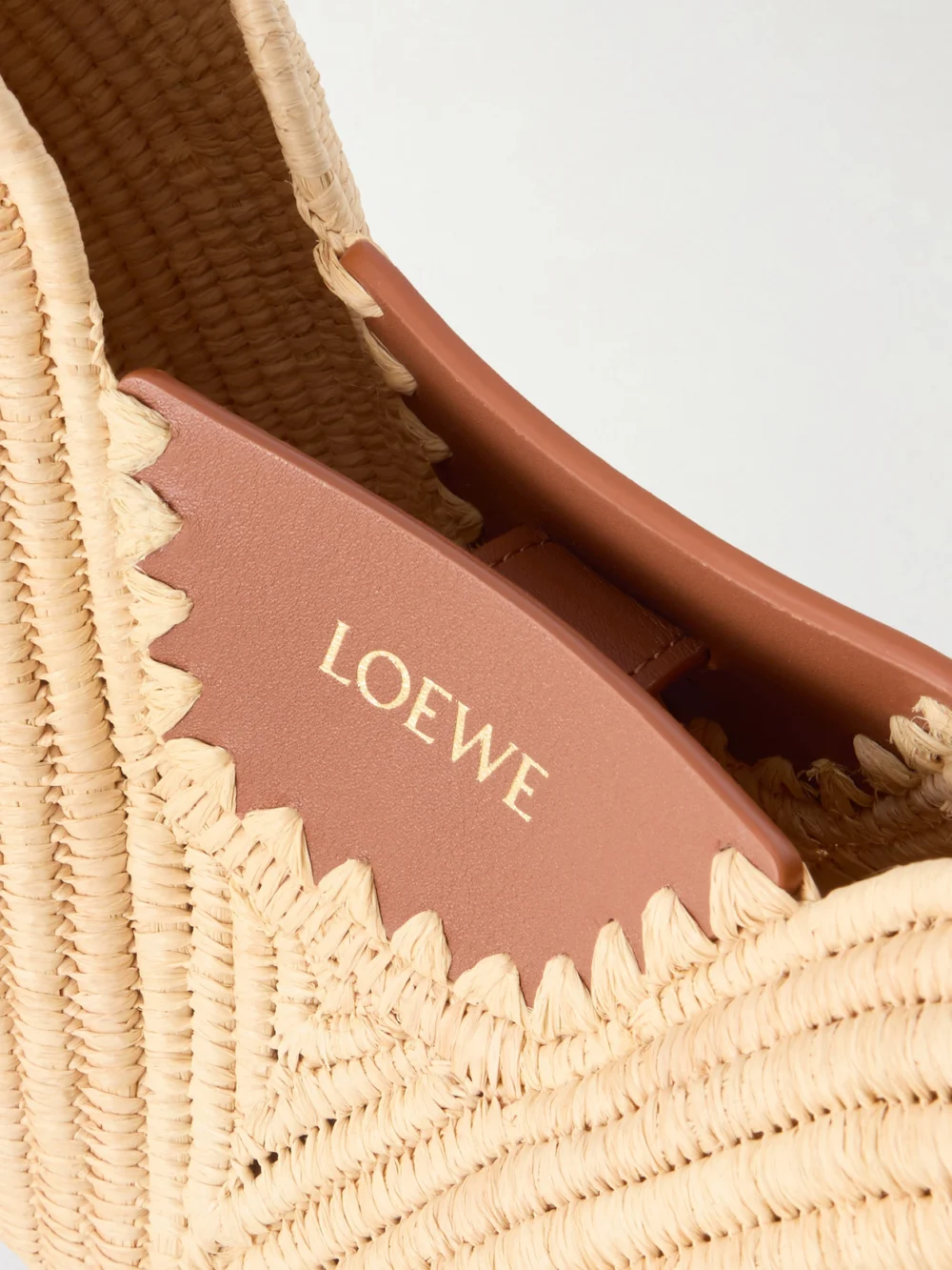 Close-up detail of the Loewe + Paula's Ibiza Swing Medium Leather-trimmed Raffia Shoulder Bag