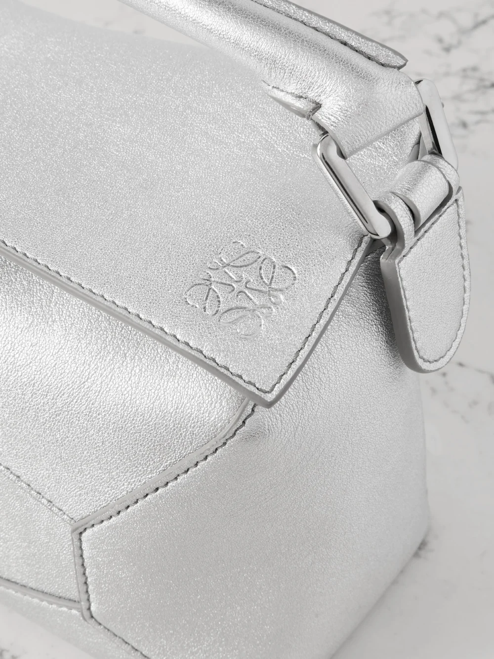 Close-up detail of the Loewe Puzzle Edge Mini Metallic Textured-leather Shoulder Bag