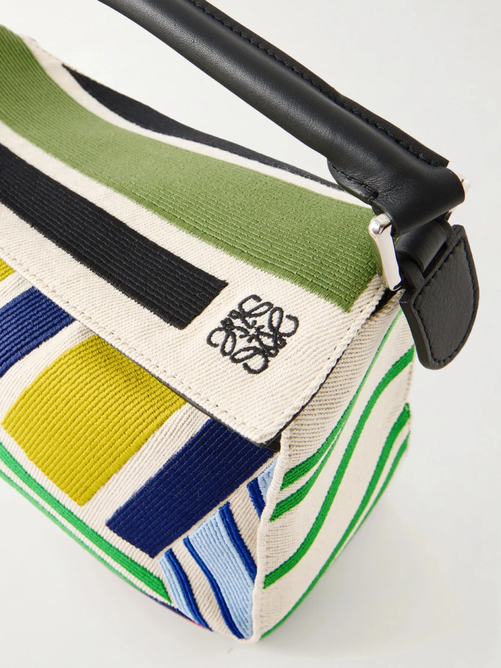 Close-up detail of the Loewe Puzzle Striped Leather-trimmed Canvas Top-handle Bag