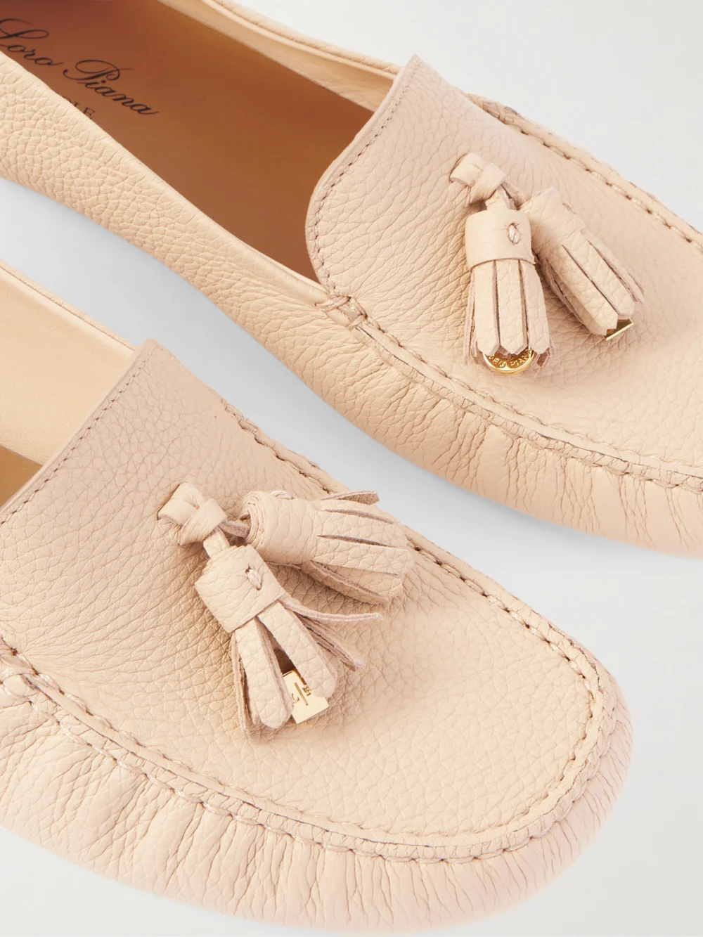 Close-up detail of the Loro Piana Tasseled Textured-leather Collapsible-heel Loafers