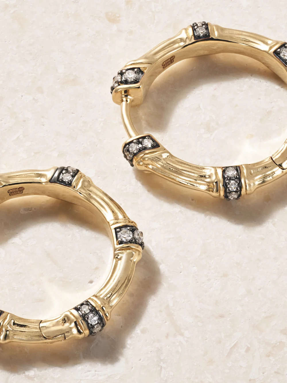 Close-up detail of the Lucy Delius Sciura 14-karat Gold Rhodium-plated Diamond Hoop Earrings