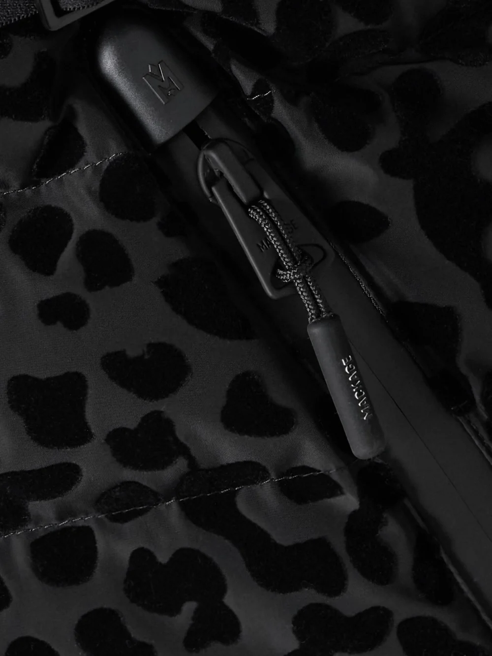Close-up detail of the Mackage Elita Hooded Belted Shearling-trimmed Flocked Down Ski Jacket