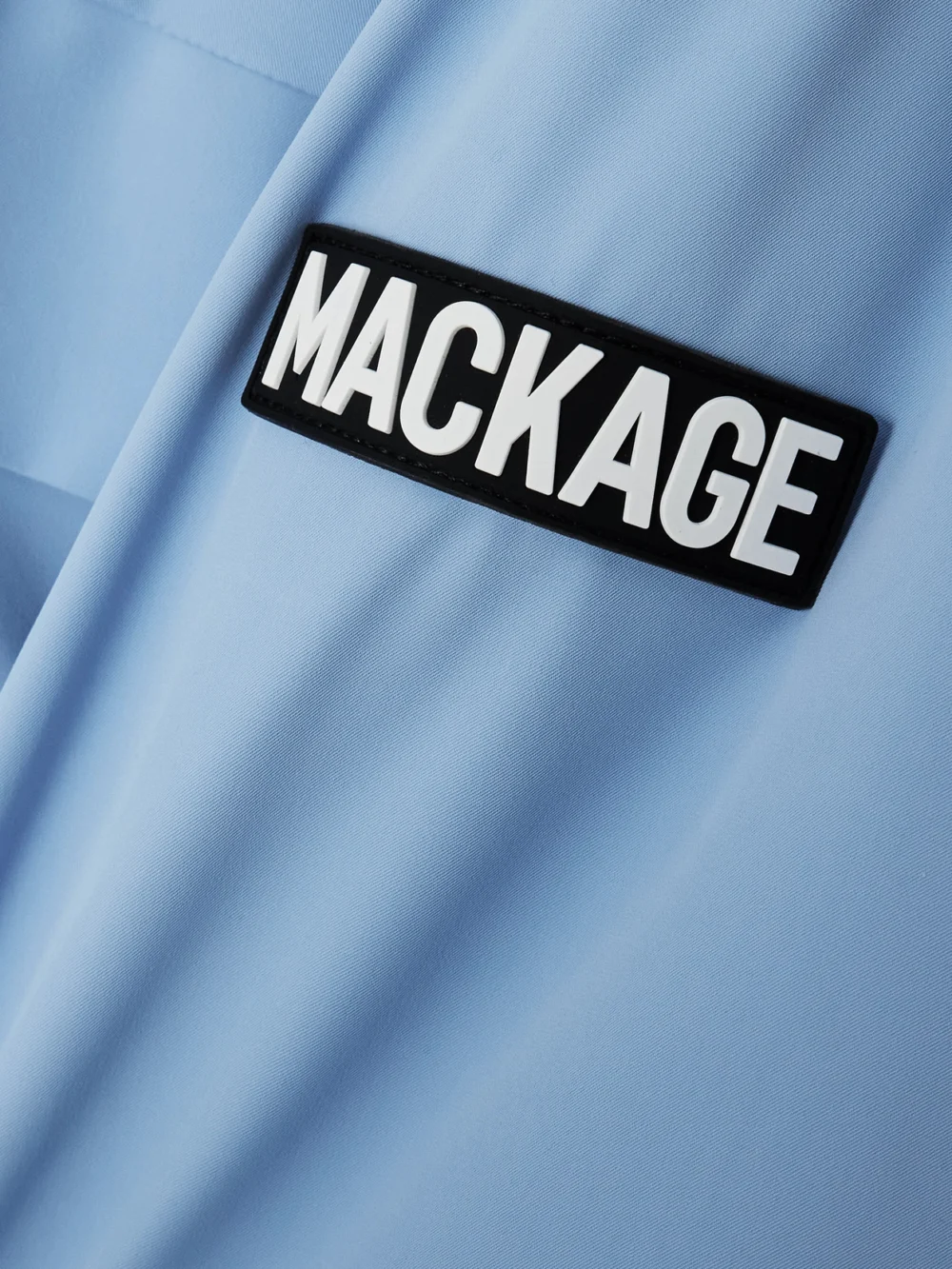 Close-up detail of the Mackage Iclyn-r Hooded Appliquéd Down Ski Jacket