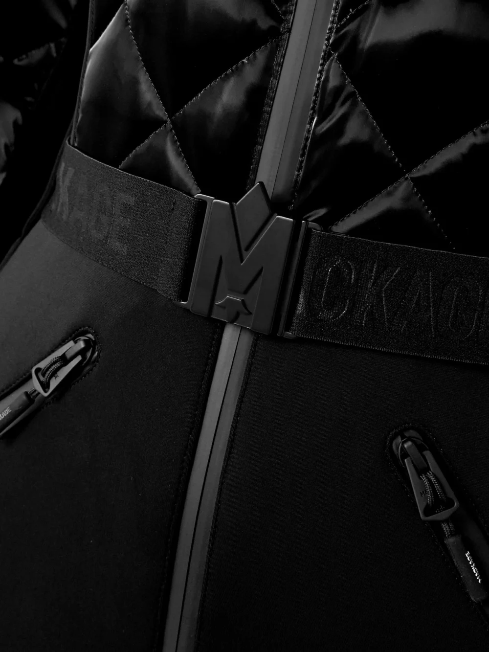 Close-up detail of the Mackage Inga Belted Quilted Padded Down Ski Suit