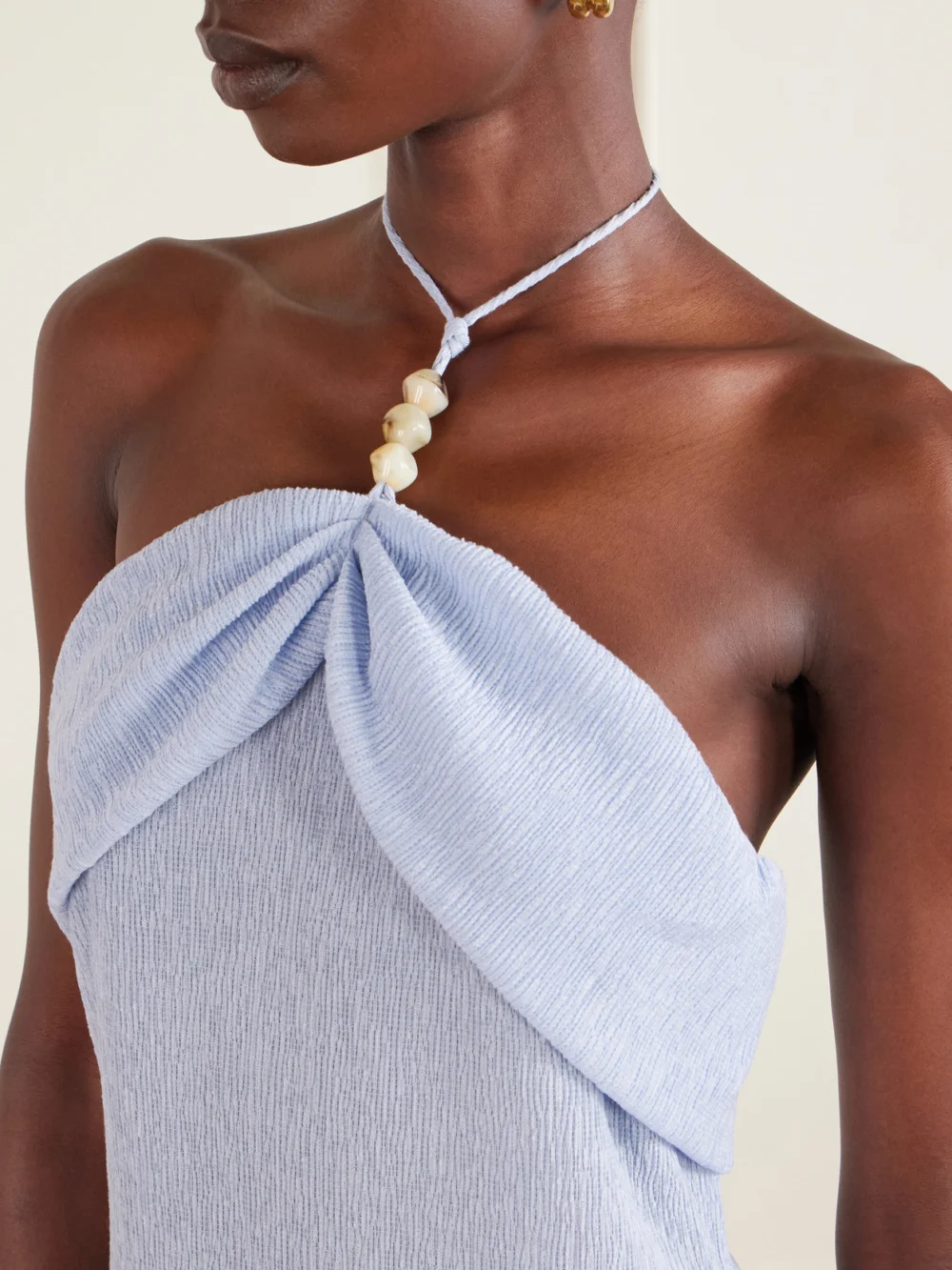 Close-up detail of the Magda Butrym Embellished Gathered Textured Lyocell-blend Halterneck Maxi Dress