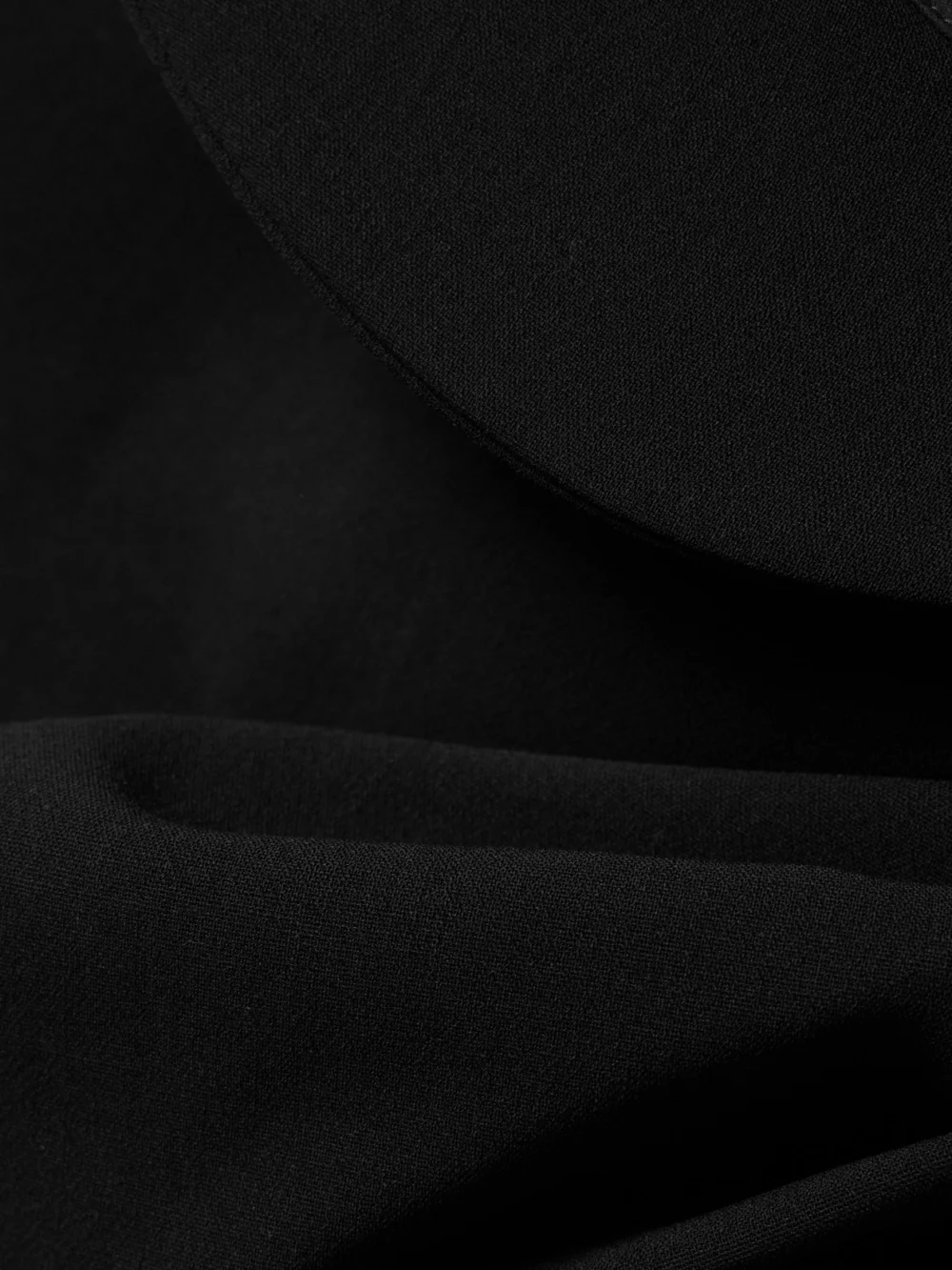 Close-up detail of the Magda Butrym Wrap-effect Draped Wool-blend Crepe Mini Dress