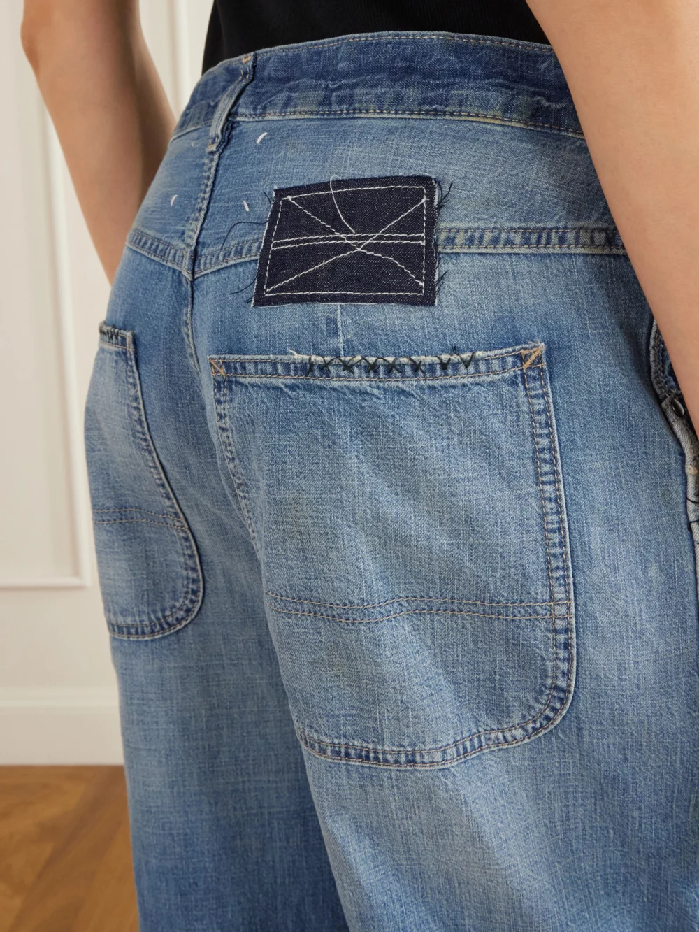 Close-up detail of the Maison Margiela Distressed Mid-rise Wide-leg Jeans