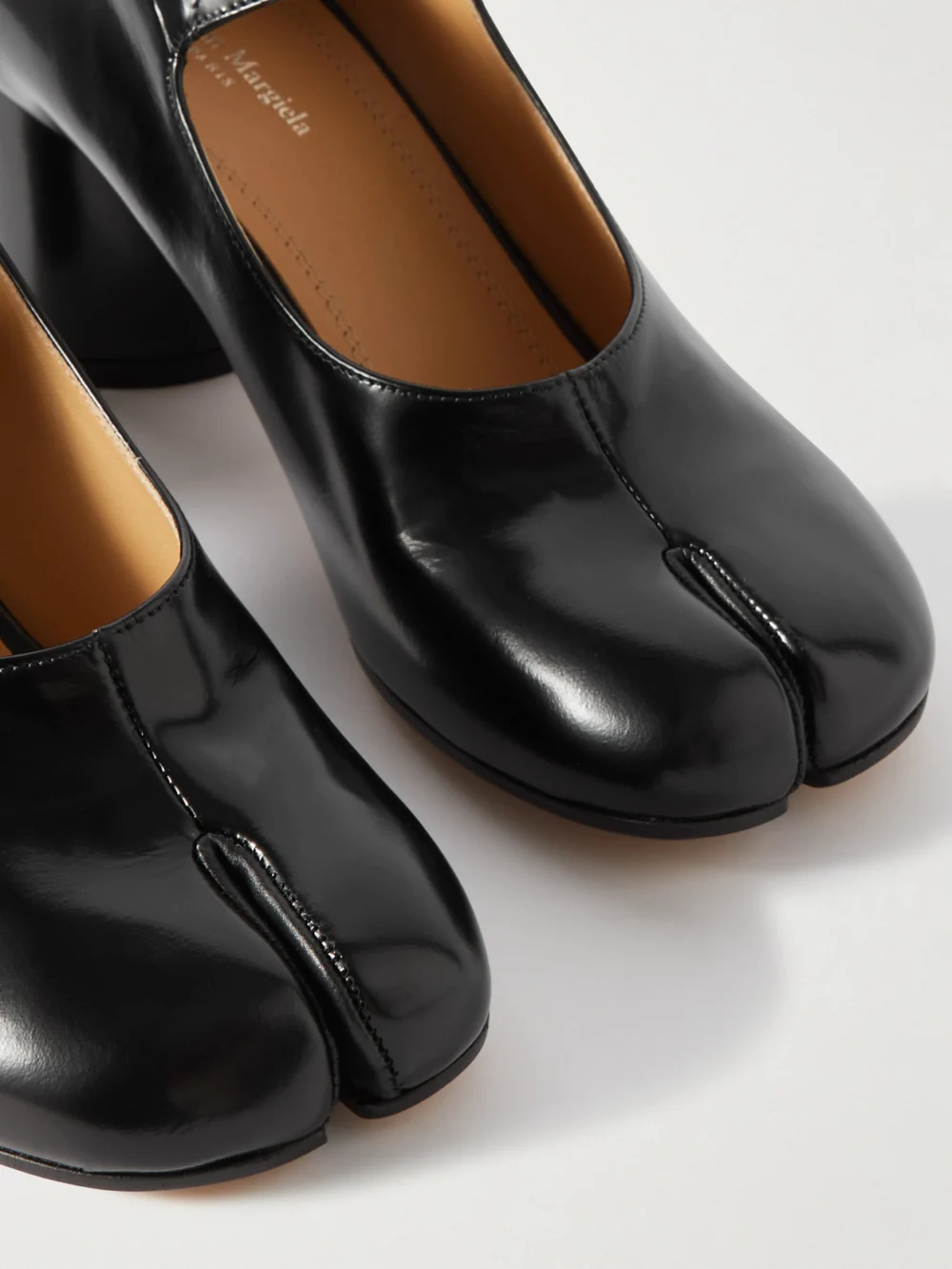 Close-up detail of the Maison Margiela Tabi Split-toe Glossed-leather Mary Jane Pumps